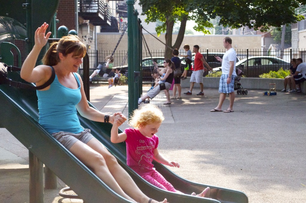 adult and child sliding on playground